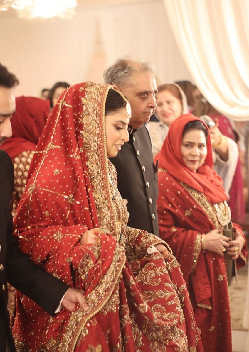 Bride in red with family