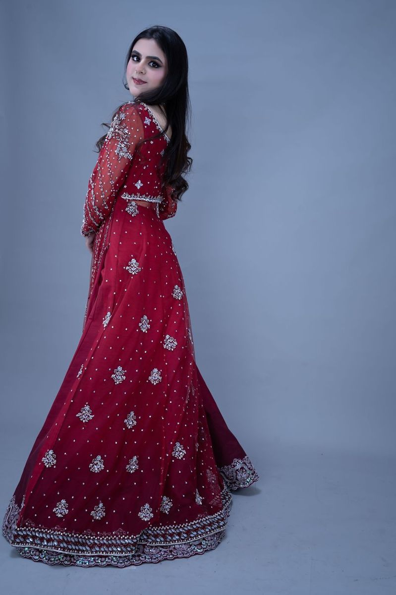 Bride in a scarlet gown with silver work