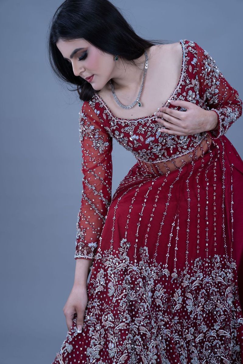 Bride in a scarlet gown with silver work