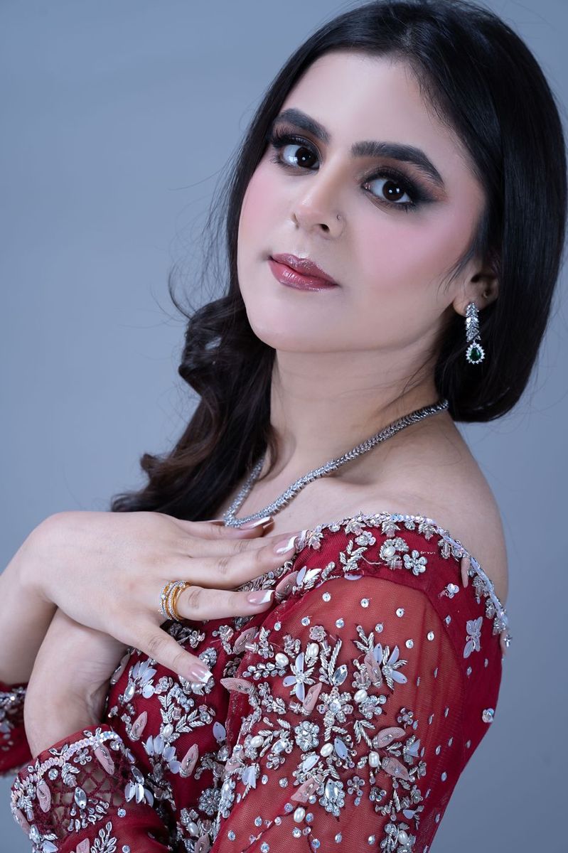 Bride in a scarlet gown with silver work