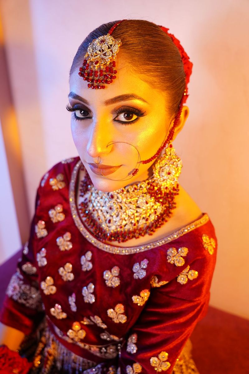 Bride in maroon velvet with gold work