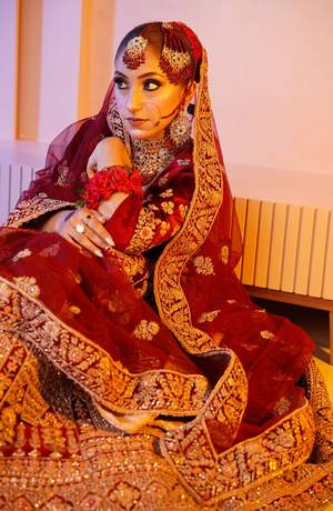 Bride in maroon velvet with gold work